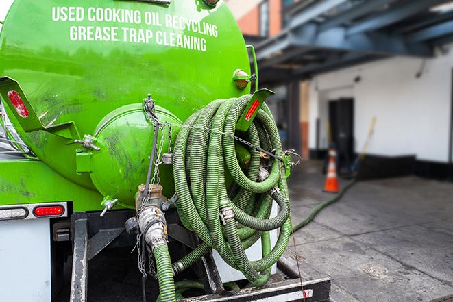 large truck pumping grease trap at a restaurant in Allentown